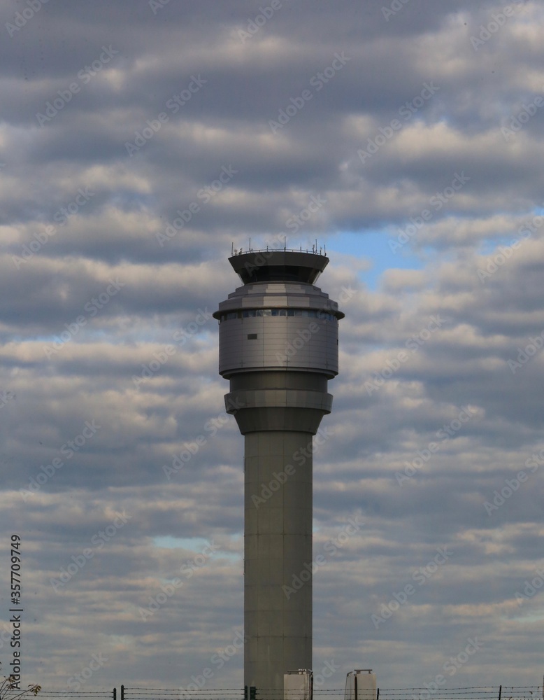 Airport control tower on a cloudy sky
