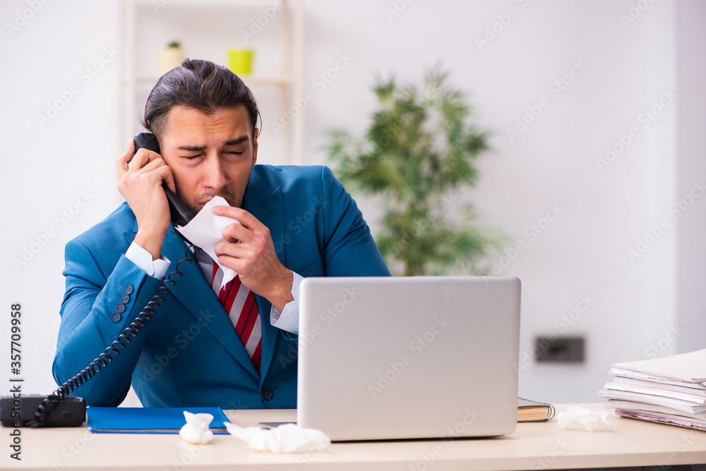 Sick male employee suffering at workplace from coronavirus Sick male employee suffering at workplace from coronavirus