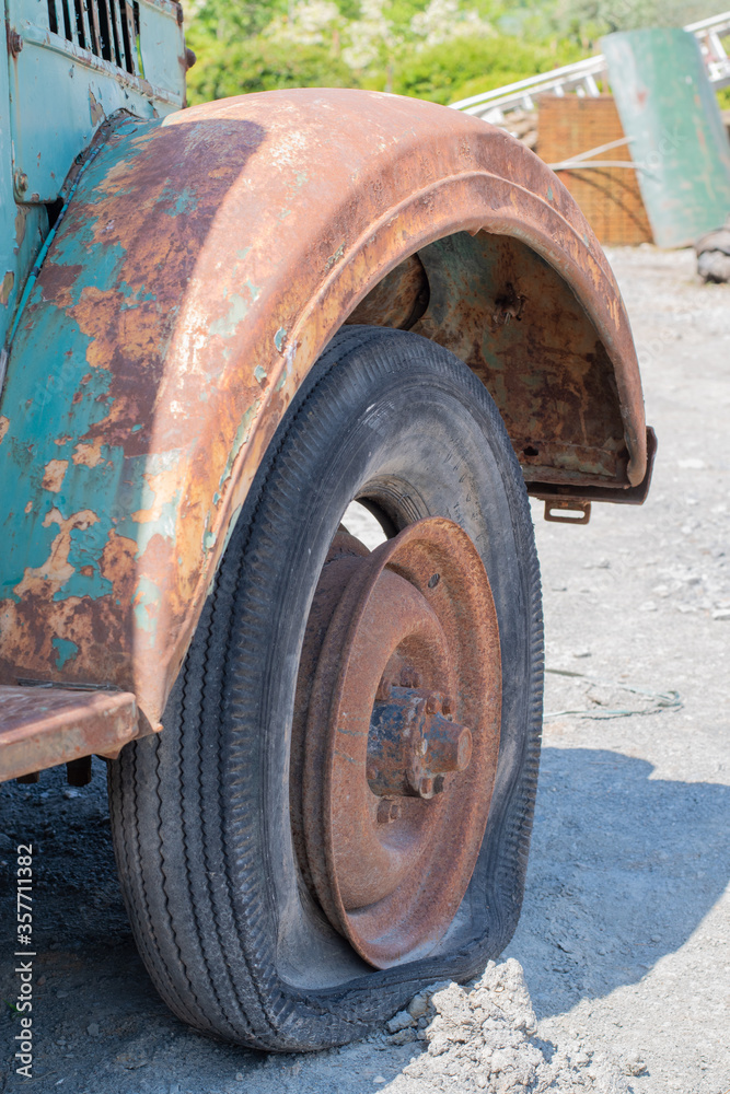 an old car wheel, an anchored iron
an old car wheel, an anchored iron