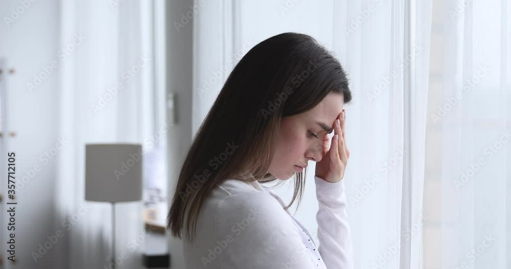 Head shot side view upset worried young brunette woman, looking out of window, thinking of problems. Depressed nervous millennial lady feeling doubtful about hard decision, mental stress concept. Head shot side view upset worried young brunette woman, looking out of window, thinking of problems. Depressed nervous millennial lady feeling doubtful about hard decision, mental stress concept.