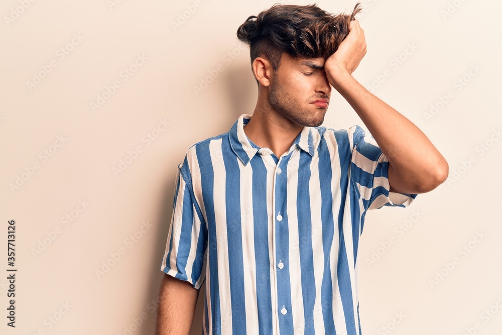 Young hispanic man wearing casual clothes surprised with hand on head for mistake, remember error. forgot, bad memory concept. Young hispanic man wearing casual clothes surprised with hand on head for mistake, remember error. forgot, bad memory concept.