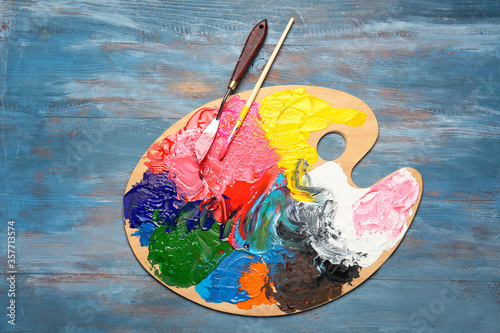Fototapeta Naklejka Na Ścianę i Meble -  Artist's palette with paints on wooden background