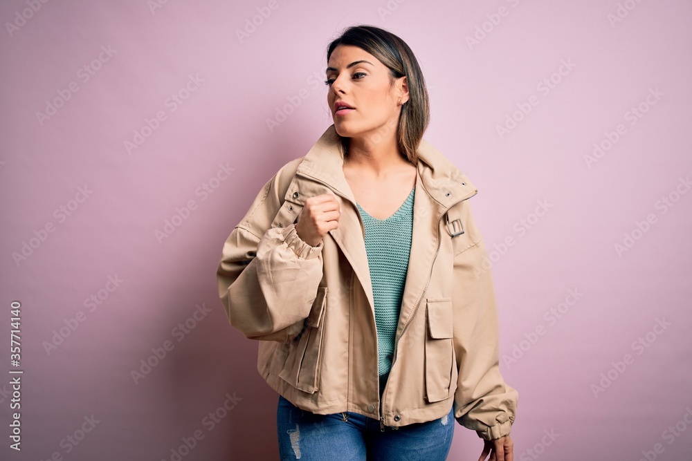 Young beautiful woman wearing fashion urban clothes, model wearing casual street style standing over pink background Young beautiful woman wearing fashion urban clothes, model wearing casual street style standing over pink background