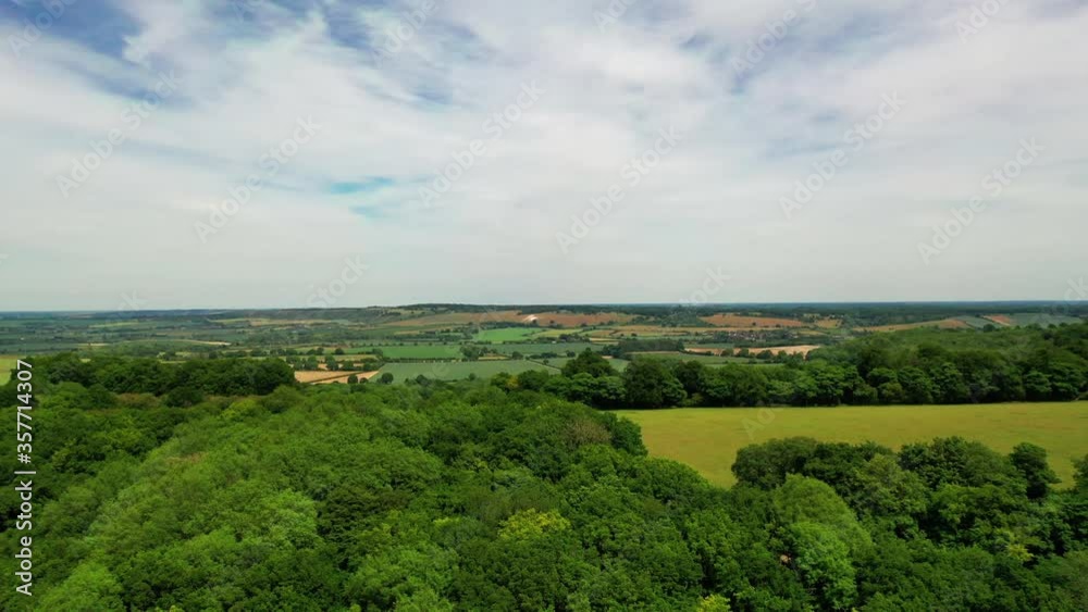 Aerial shot over a forest and English agricultural land, on a bright sunny day. Aerial shot over a forest and English agricultural land, on a bright sunny day.