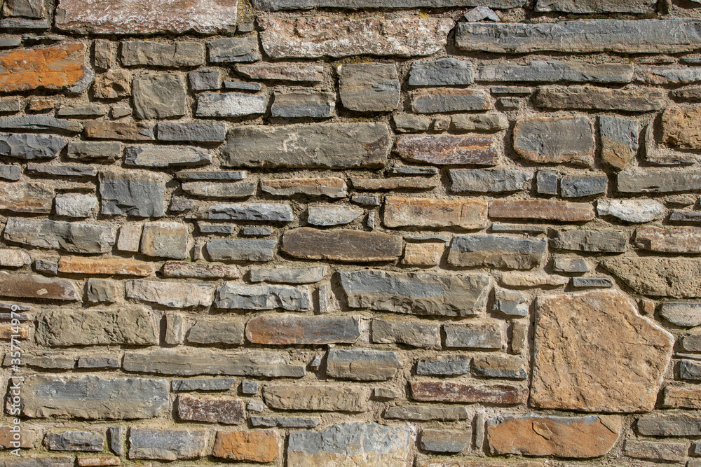 Texture rock colored. Background wall rocks and stones. Exterior walls of natural mountain materials and minerals. 
Street wall of graffiti.