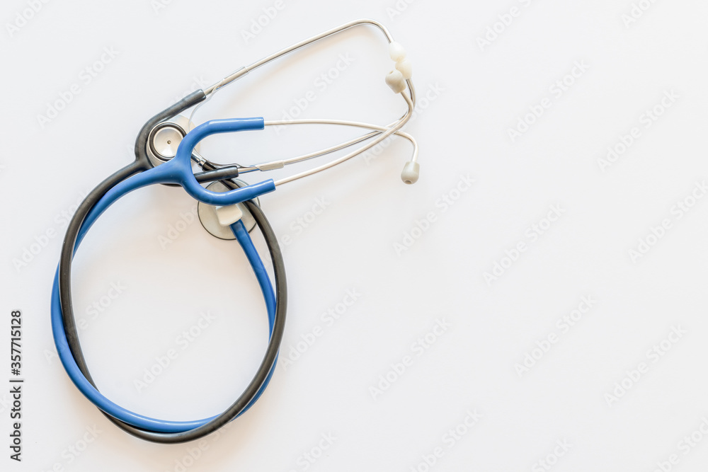 two blue and black stethoscopes on a white background two blue and black stethoscopes on a white background