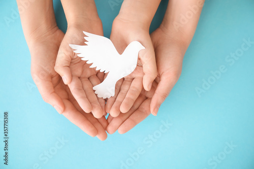Hands of family with paper ...