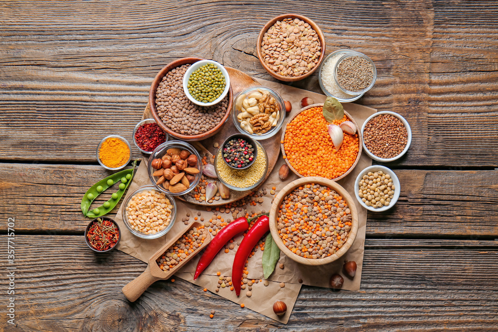 Different raw legumes with spices on table Different raw legumes with spices on table