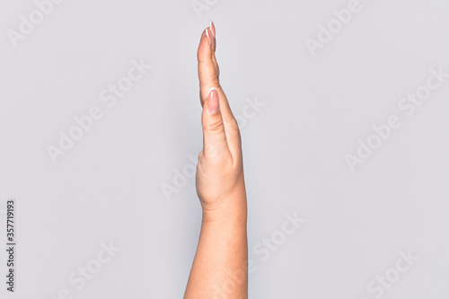 Hand of caucasian young woman showing the side of stretched hand  pushing and doing stop gesture