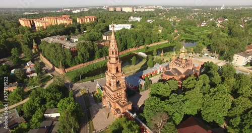 4K aerial summer morning video of red brick Gefsimanskiy skit grand cathedral church with golden cupolas in small vintage town Sergiev Posad in Moscow Oblast in central Russia