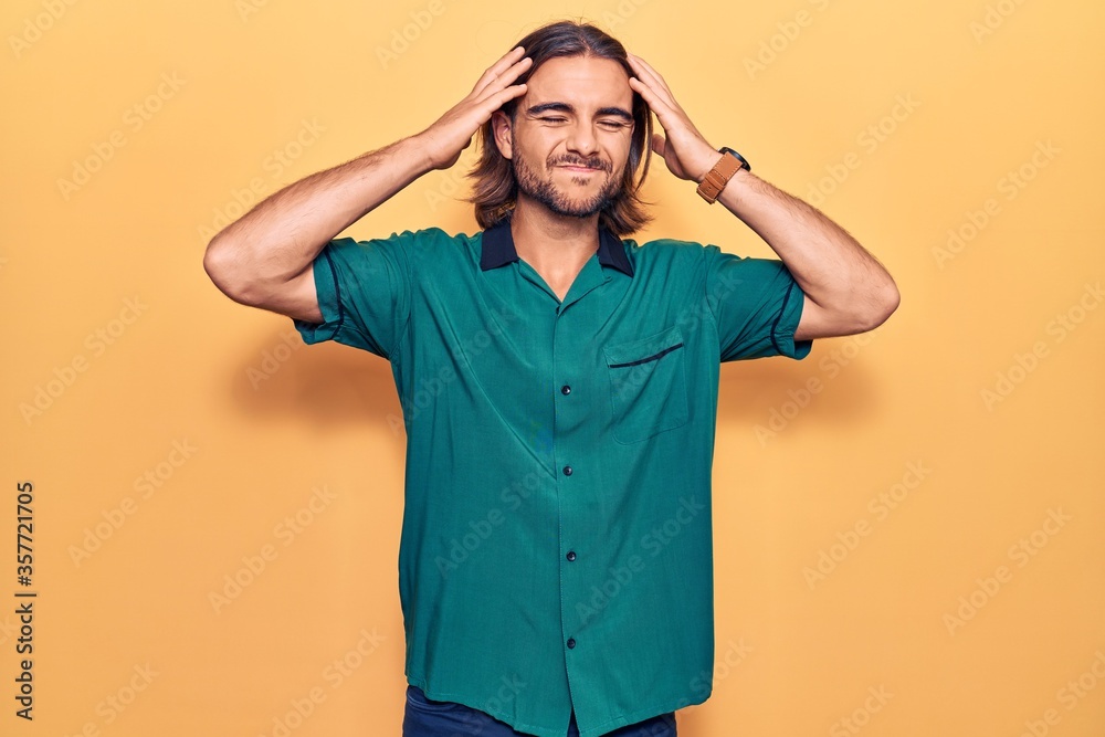 Young handsome man wearing casual clothes with hand on head, headache because stress. suffering migraine. Young handsome man wearing casual clothes with hand on head, headache because stress. suffering migraine.
