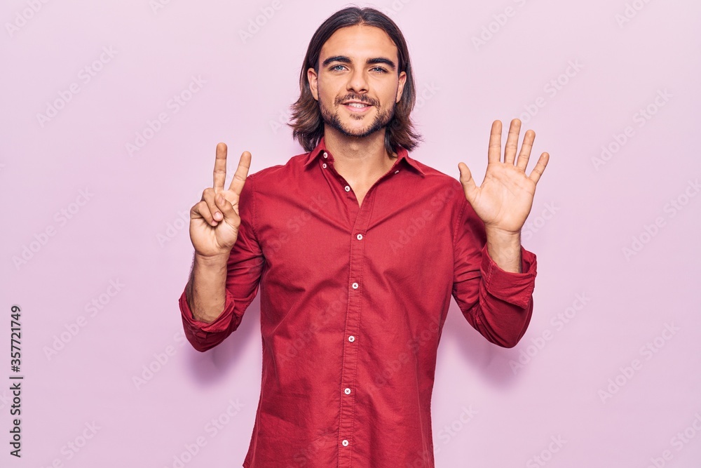Young handsome man wearing business clothes showing and pointing up with fingers number seven while smiling confident and happy. Young handsome man wearing business clothes showing and pointing up with fingers number seven while smiling confident and happy.