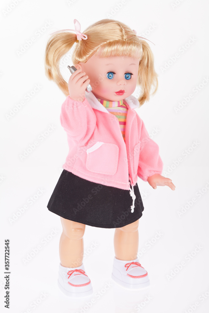 Doll with cell phone toy in white background. Doll with cell phone toy in white background.