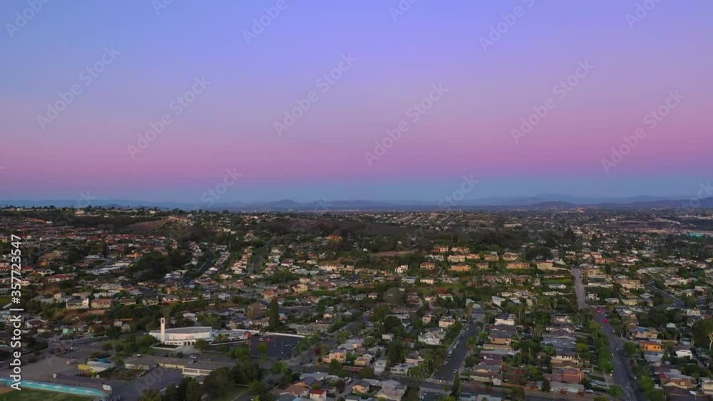 Aerial shot of buildings in city against sky during sunset, drone flying forward over cityscape - San Diego, California Aerial shot of buildings in city against sky during sunset, drone flying forward over cityscape - San Diego, California
