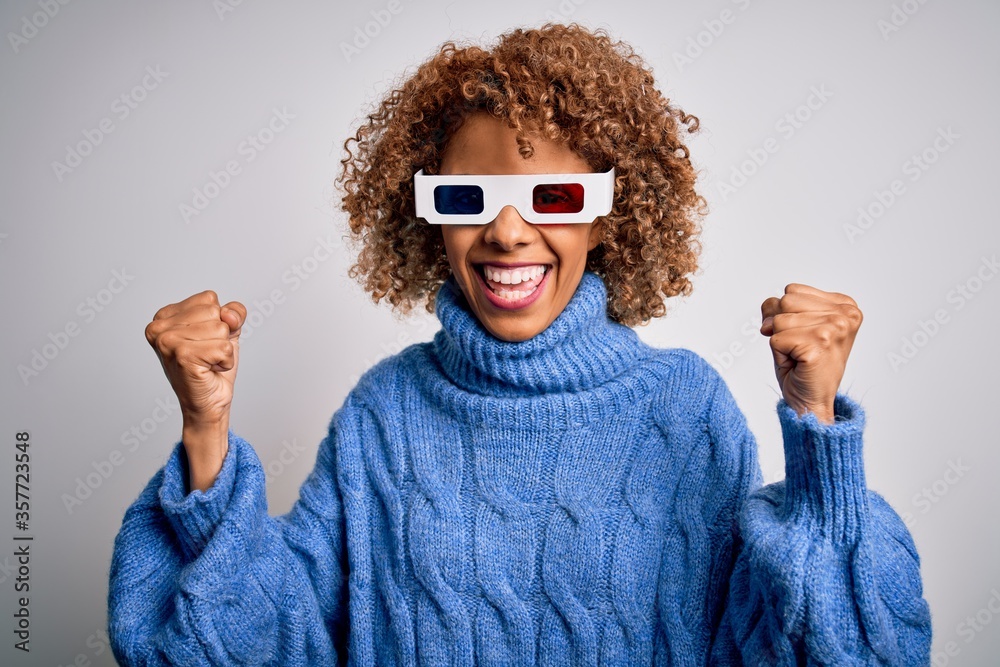 Young african american curly woman wearing 3d glasses over isolated white background celebrating surprised and amazed for success with arms raised and open eyes. Winner concept. Young african american curly woman wearing 3d glasses over isolated white background celebrating surprised and amazed for success with arms raised and open eyes. Winner concept.