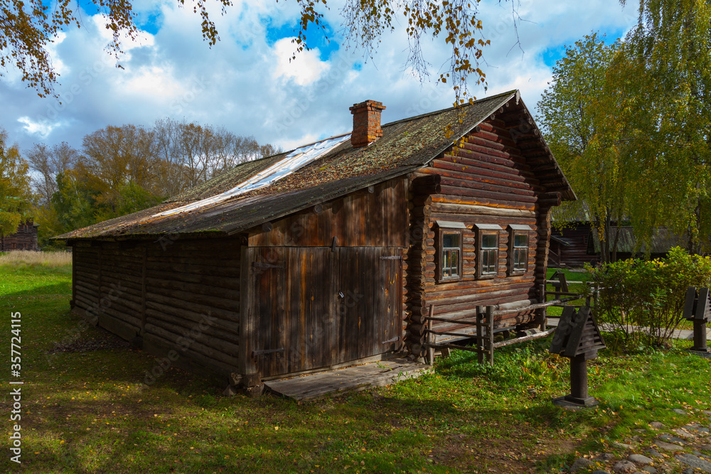 Obraz premium An old blackened from time log Russian house stands among trees