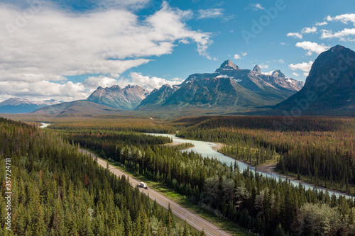 Aerial view of vehicles on scenic Icefields Parkway highway between Banff and Jasper National Parks during summer in Alberta, Canada.