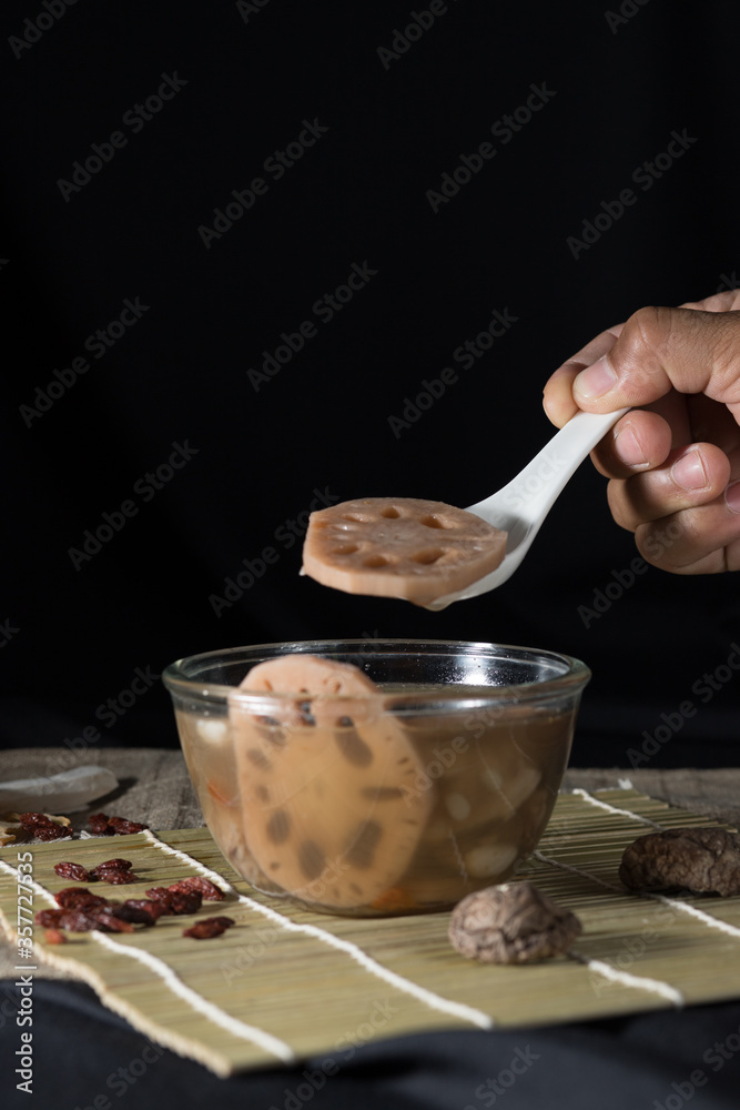 Lotus root soup with beans in a bowl and Chinese herbs, shiitake mushroom, lotus root Lotus root soup with beans in a bowl and Chinese herbs, shiitake mushroom, lotus root
