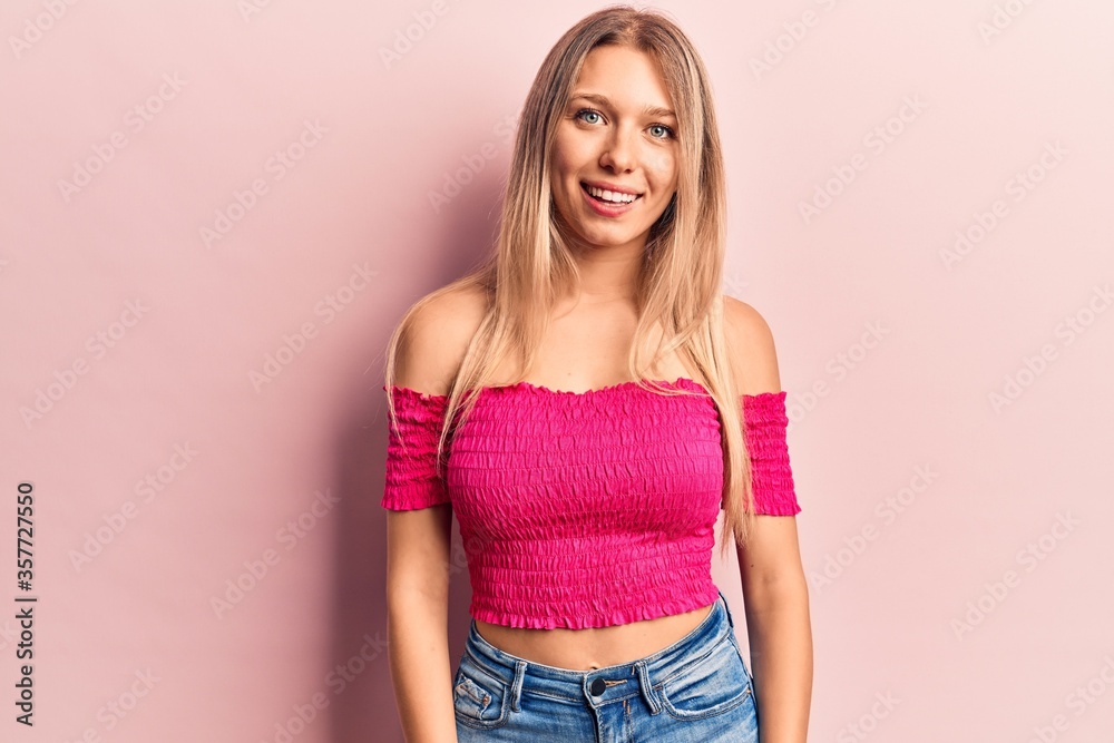 Young blonde woman wearing casual clothes with a happy and cool smile on face. lucky person. Young blonde woman wearing casual clothes with a happy and cool smile on face. lucky person.