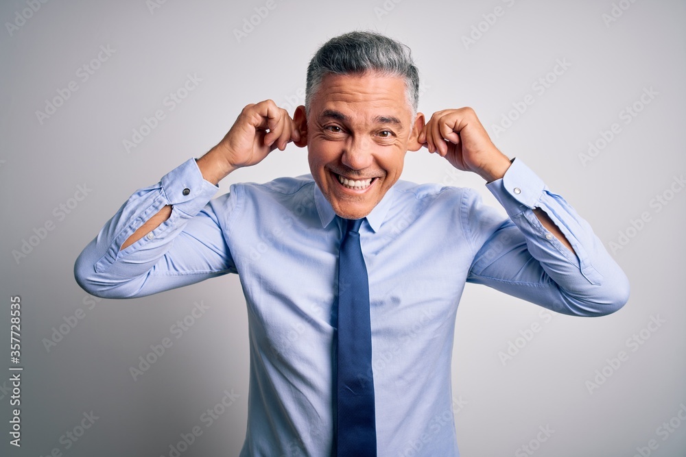 Middle age handsome grey-haired business man wearing elegant shirt and tie Smiling pulling ears with fingers, funny gesture. Audition problem Middle age handsome grey-haired business man wearing elegant shirt and tie Smiling pulling ears with fingers, funny gesture. Audition problem