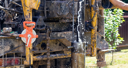 Drilling rig, drill pipe lifting. A fountain of water pours out of the pipes. Strength and energy photo