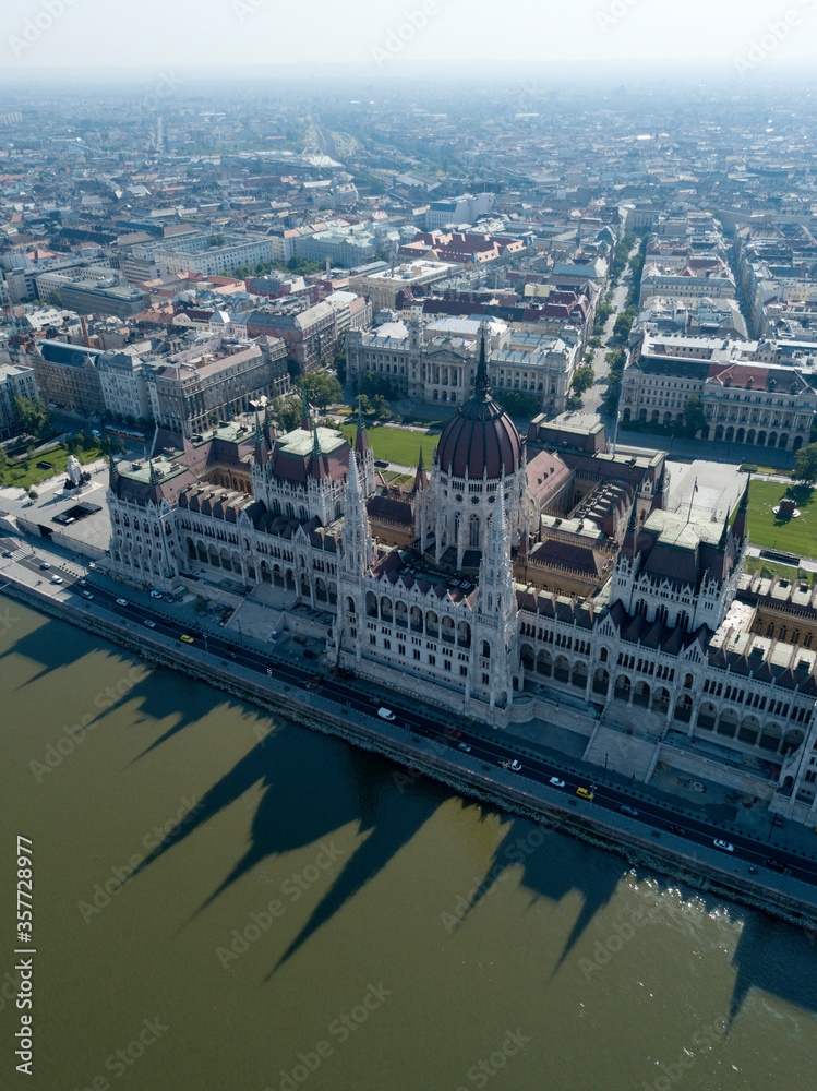 Aerial footage of Parliament of Budapest, Hungarian parliament building on the riverside of Danube. Orszaghaz, Budapest city, Hungary, Europe. Summer. Neo gothic architecture. Travel destination
