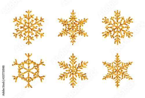 Sparkling winter snowflake set. Golden glitter texture of crystal ice, sparkling light effect. Christmas decor snow symbol. Great for decorating New Year invitation cards. Isolated vector illustration
