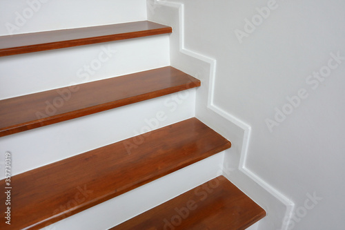 brown wooden stair and white wall in residential house