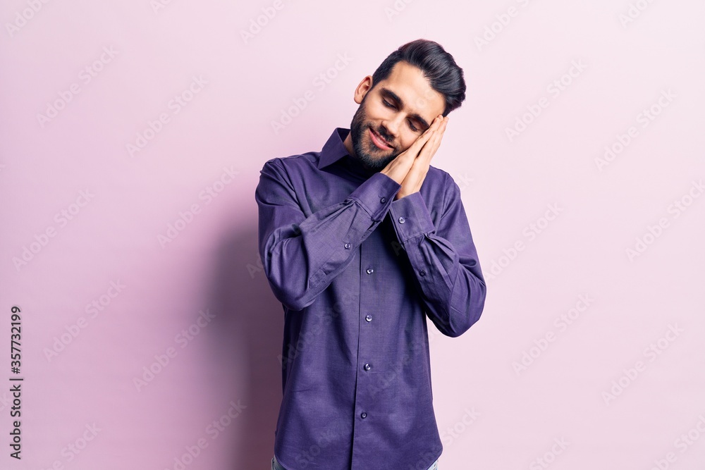 Young handsome man with beard wearing casual shirt sleeping tired dreaming and posing with hands together while smiling with closed eyes. Young handsome man with beard wearing casual shirt sleeping tired dreaming and posing with hands together while smiling with closed eyes.