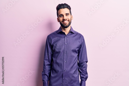 Young handsome man with beard wearing casual shirt with a happy and cool smile on face. lucky person. © Krakenimages.com