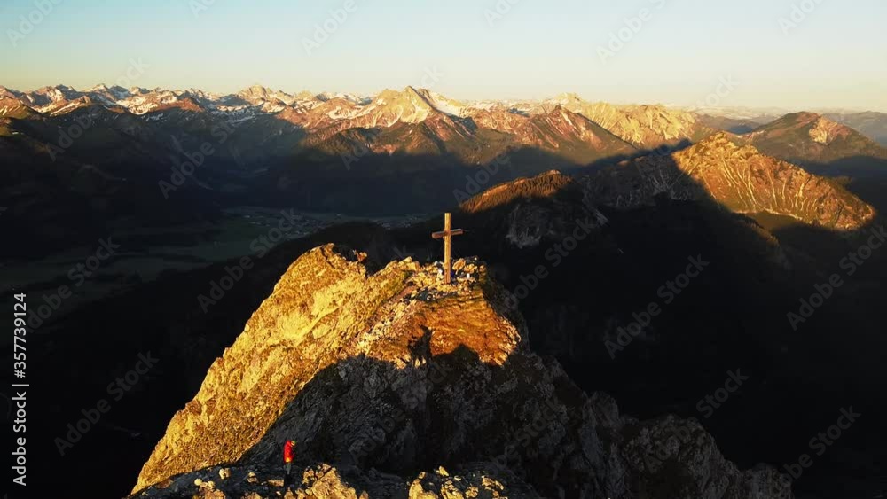 Parallaxe around a mountaintop at sunrise with drone