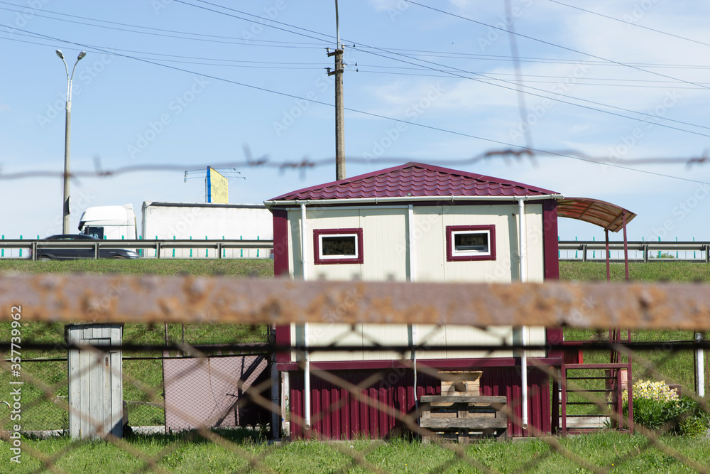 The house of a caretaker, a point of protection in a fenced area of a paid parking lot or warehouse. Protected area close to the track. The house of a caretaker, a point of protection in a fenced area of a paid parking lot or warehouse. Protected area close to the track.