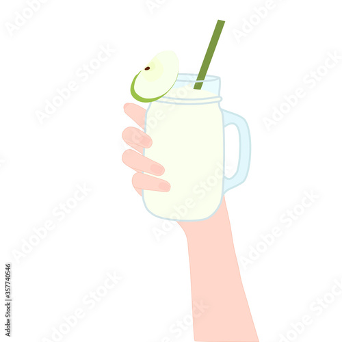 Hand is holding​ a smoothie juice in a glass cup with and has green apple slice on top. The cold beverage for the summer season. Healthy and organic drink.