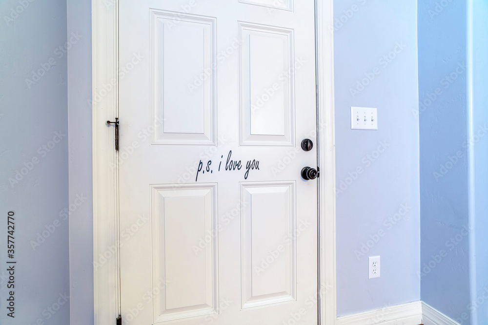White interior wooden door in a blue wall White interior wooden door in a blue wall
