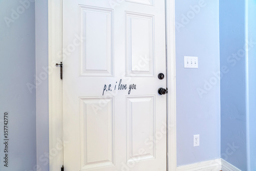 Fototapeta Naklejka Na Ścianę i Meble -  White interior wooden door in a blue wall