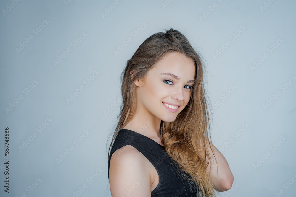 Young beautiful cute cheerful girl smiling looking at camera over white background. Portrait of happy young girl looking at camera. Young beautiful cute cheerful girl smiling looking at camera over white background. Portrait of happy young girl looking at camera.