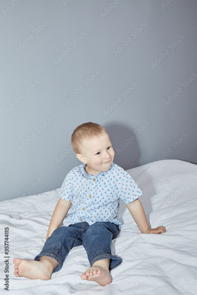 Toddler in a shirt and pants on a gray background Toddler in a shirt and pants on a gray background