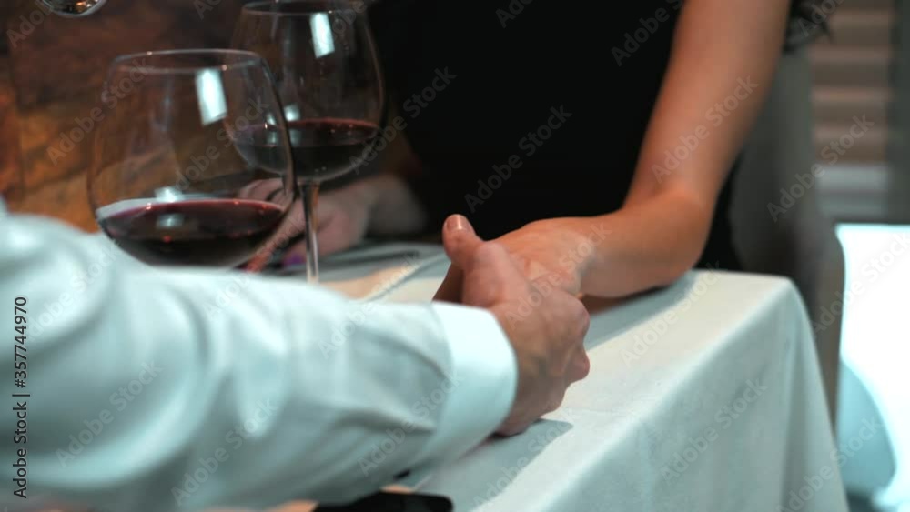Couple holding hands during romantic dinner in a restaurant , Saint Valentines day