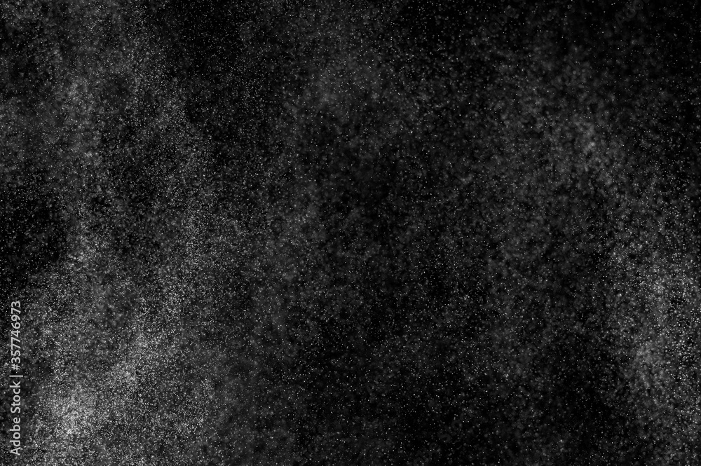 Fototapeta premium Abstract splashes of water on black background. Freeze motion of white particles. Rain, snow overlay texture.
