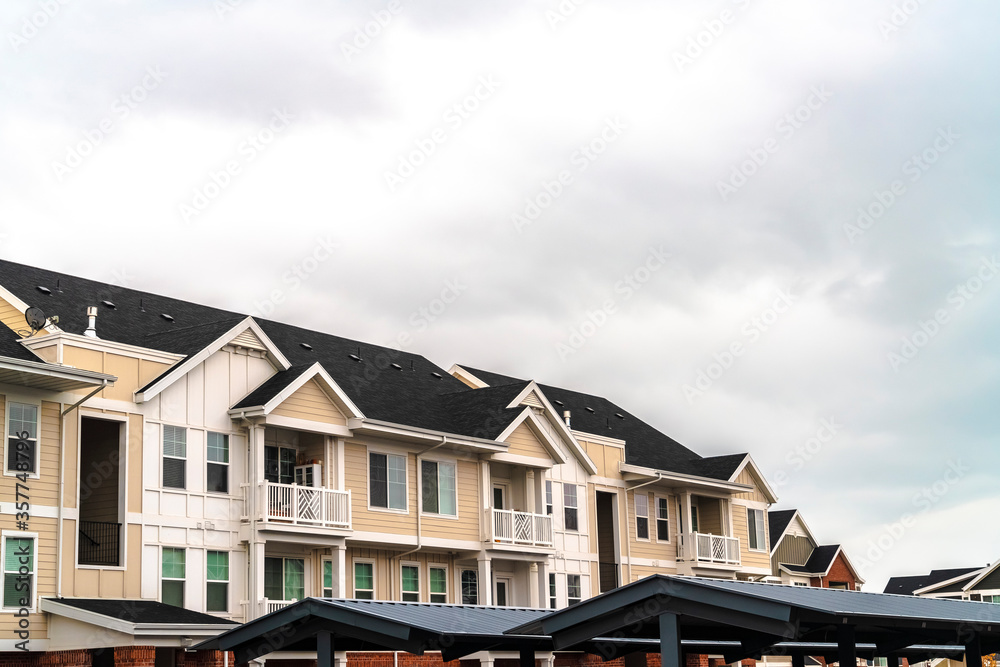 Modern apartment complex with covered parking day light Modern apartment complex with covered parking day light