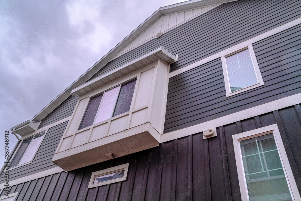 House facade with narrow balcony day light House facade with narrow balcony day light