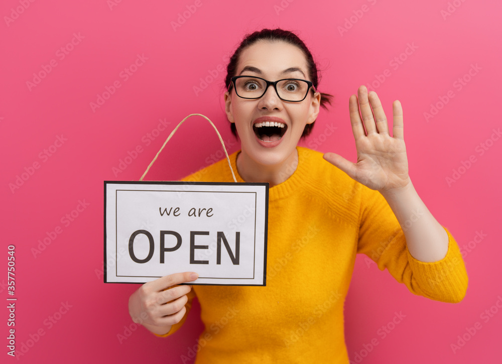business owner holding the sign for the reopening business owner holding the sign for the reopening