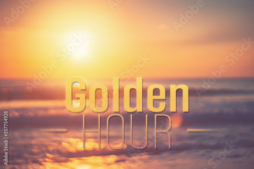 Golden hour words on blur tropical sand beach with bokeh sunlight wave abstract background. Copy space of business summer vacation and travel adventure concept.
