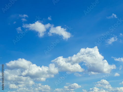 White fluffy clouds in the blue sky. Summer  cloudy. The air  the atmosphere.