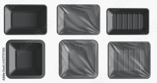 Black plastic food container. Styrofoam tray for frozen food and fresh meat, fish, chicken. Empty food package with clear wrap isolated. Blank plastic tray template set on transparent background