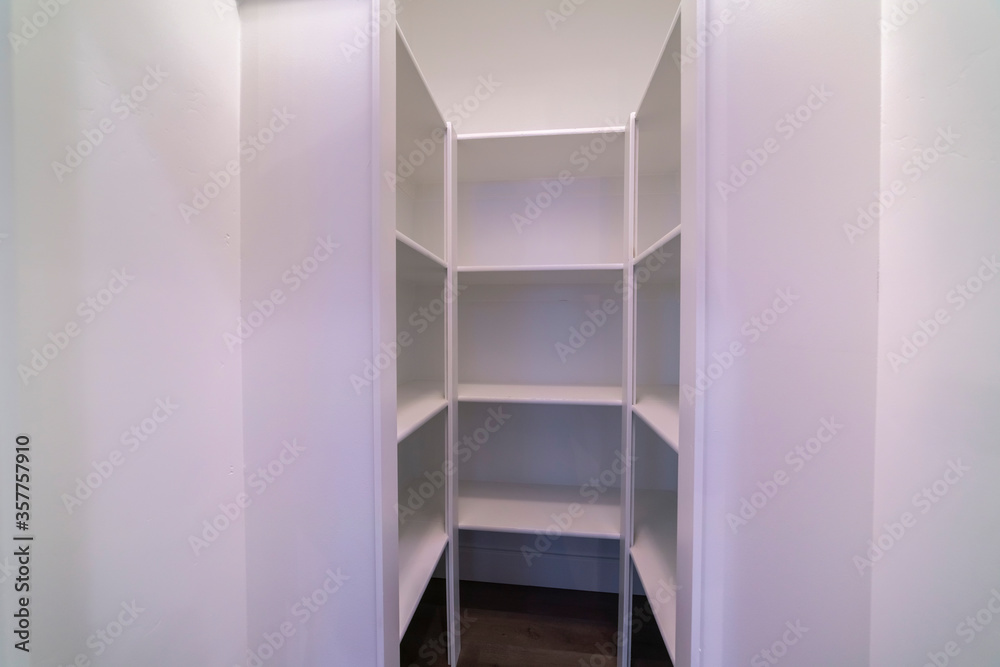 Fototapeta premium Empty interior of a walk-in wardrobe interior