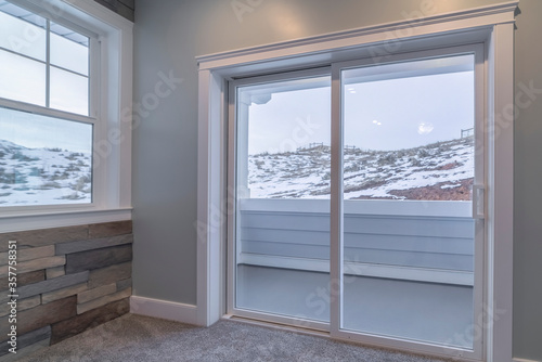 View through glass balcony doors of snow in winter