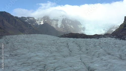 Glacier Svinafellsjokul in Southern Iceland, drone flying by towering seracs photo