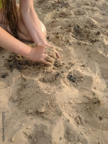 girl playing in the sand on the beach