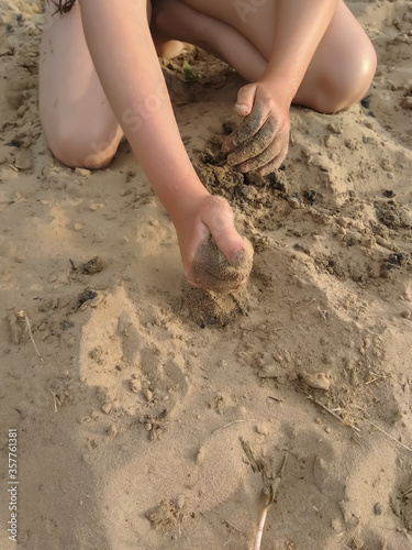  girl playing in the sand on the beach